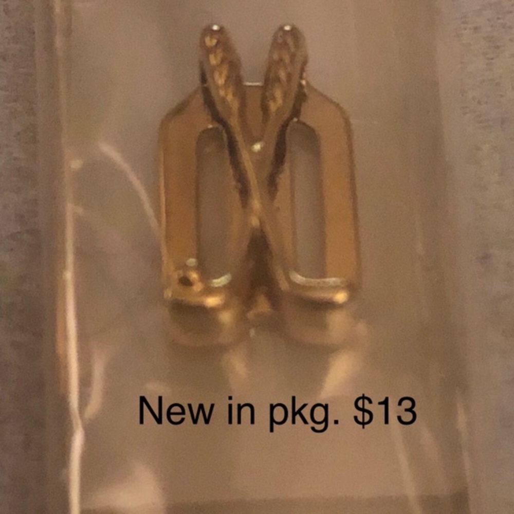 KEEP Collective gold golf clubs.